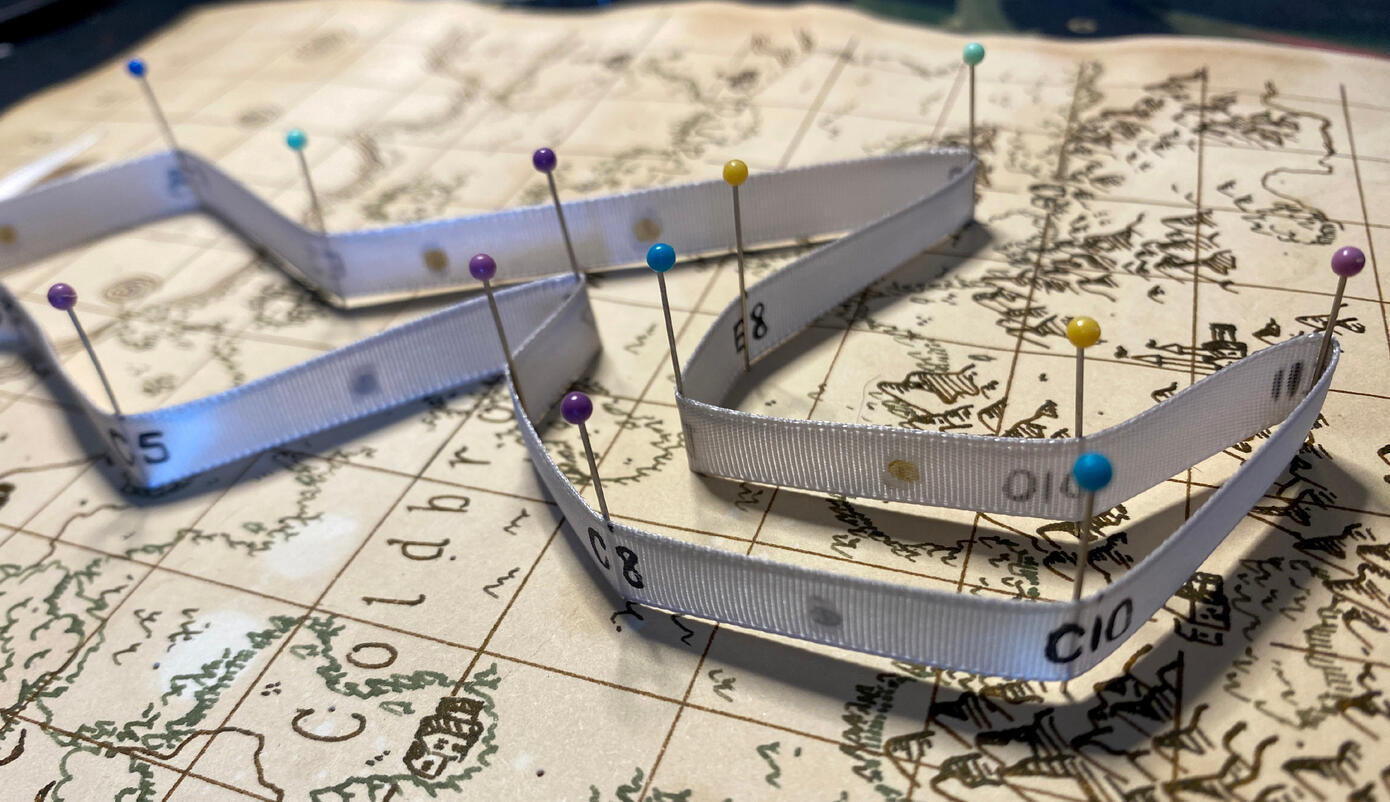 A close up of the pinned ribbon that shows the coordinates written on the ribbon.