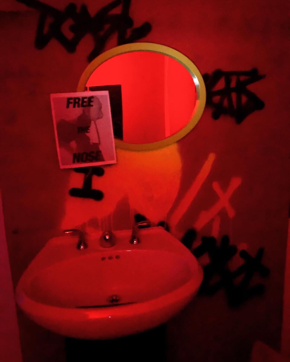 One of the Free the Nose posters on set. They were offered to audience members, who were encouraged to put them up around the experience.